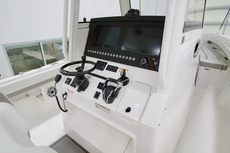 Slide: The Image of 2026 Regulator 31 boat dashboard with steering wheel and control panel. - 32