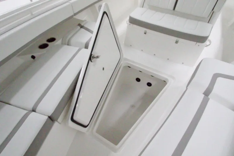 Slide: The Image of 2026 Regulator 31 boat interior with open storage compartment and cushioned seating. - 40