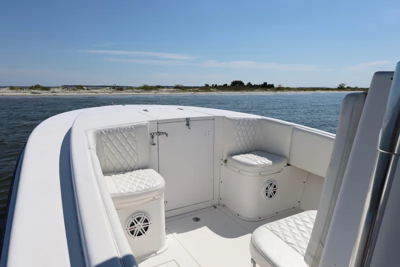 Slide: The Image of 2005 Contender 31 Cuddy boat on water, clear sky, and distant shoreline. - 14