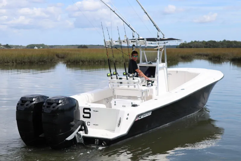 Slide: The Image of 2005 Contender 31 Cuddy boat cruising on a scenic river. - 4
