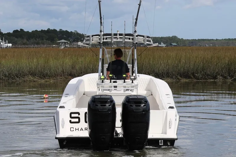 Slide: The Image of Control panel of a 2005 Contender 31 Cuddy boat with navigation screens. - 6
