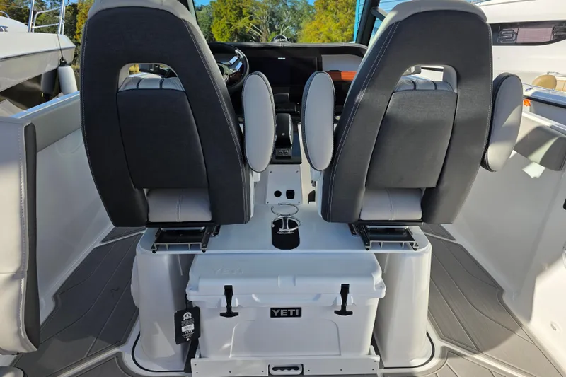 Slide: The Image of 2026 Monterey Elite 25 OB boat interior with dual seats and Yeti cooler. - 10