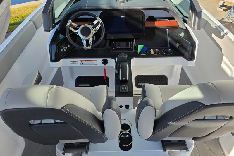 Slide: The Image of 2026 Monterey Elite 25 OB boat cockpit with modern steering and dual seats. - 11