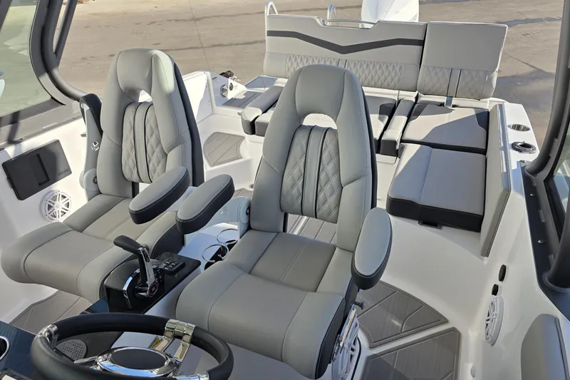 Slide: The Image of 2026 Monterey Elite 25 OB boat interior with luxurious seating and modern controls. - 18