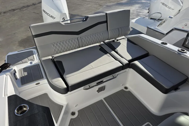 Slide: The Image of 2026 Monterey Elite 25 OB boat interior with gray seating and Mercury outboard engine. - 22