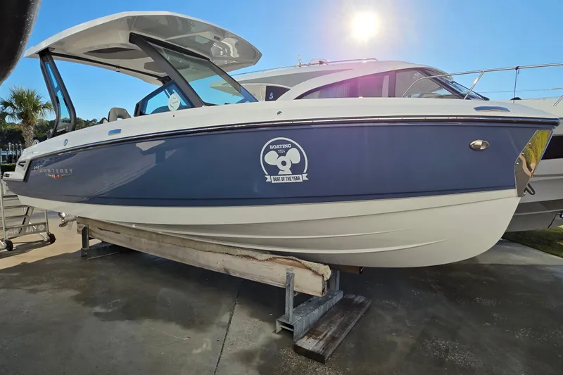 Slide: The Image of 2026 Monterey Elite 25 OB boat displayed outdoors under bright sunlight. - 3