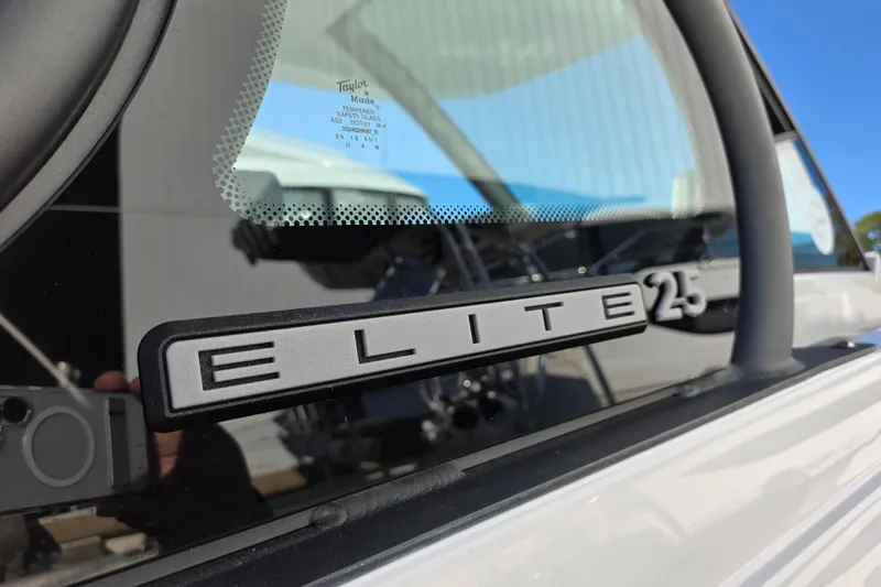 Slide: The Image of 2026 Monterey Elite 25 OB boat logo on window, showcasing sleek design. - 5
