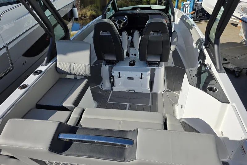 Slide: The Image of 2026 Monterey Elite 25 OB boat interior with modern seating and sleek design. - 7