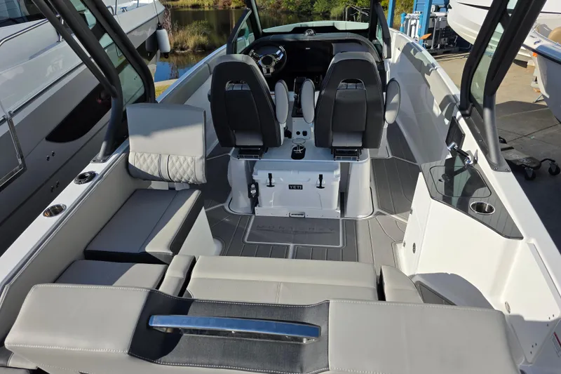 Slide: The Image of 2026 Monterey Elite 25 OB boat interior with modern seating and sleek design. - 8