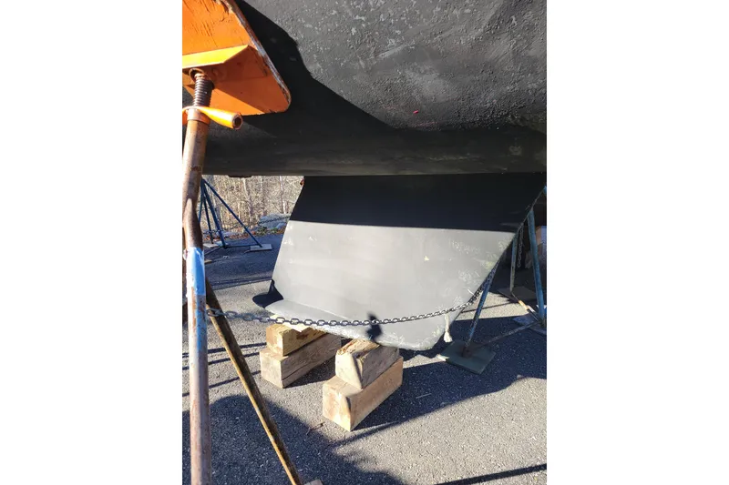 Slide: The Image of Beneteau Oceanis 300 sailboat keel, 1994 model, supported on blocks outdoors. - 15