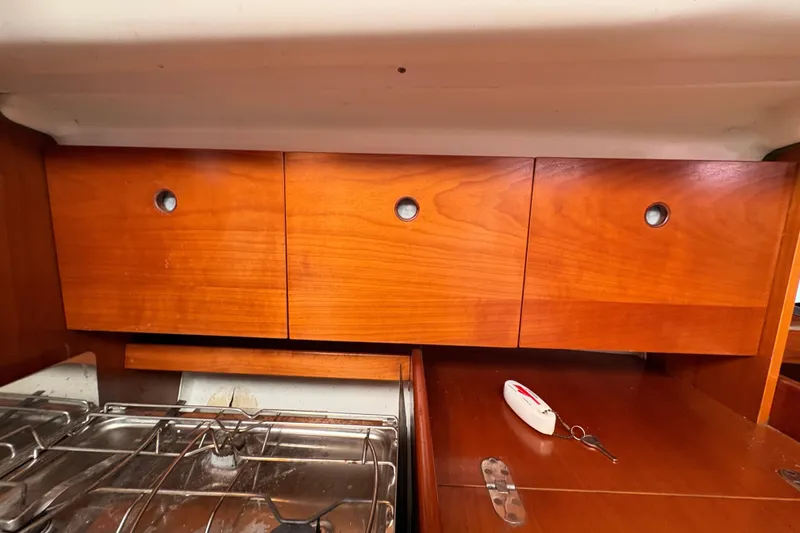 Slide: The Image of Wooden cabinets and stove in 1994 Beneteau Oceanis 300 yacht interior. - 17