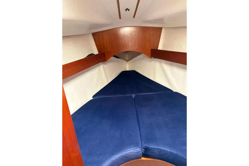 Slide: The Image of Interior cabin of 1994 Beneteau Oceanis 300 sailboat with blue cushions. - 19