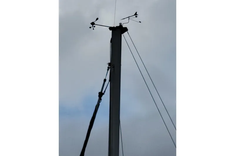 Slide: The Image of Mast of 1994 Beneteau Oceanis 300 sailboat with wind instruments against cloudy sky. - 4