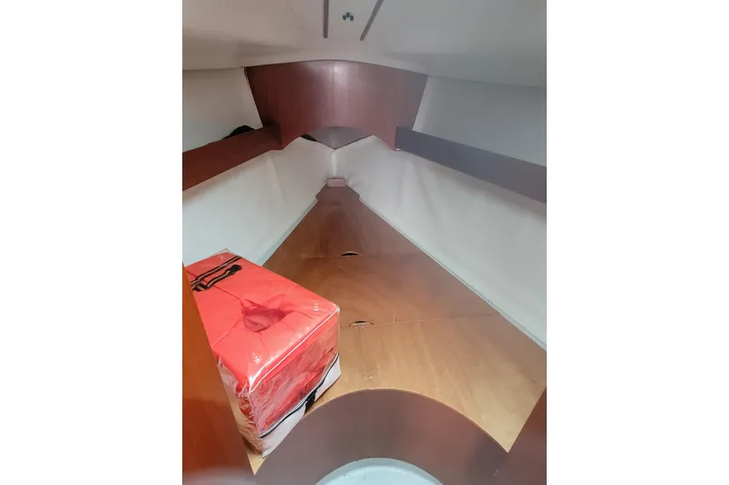 Slide: The Image of 1994 Beneteau Oceanis 300 cabin interior with wooden finish and red life jacket. - 5