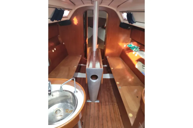 Slide: The Image of Interior of 1994 Beneteau Oceanis 300 sailboat with wooden finish and compact sink. - 9