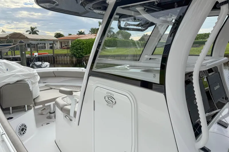 Slide: The Image of 2023 Sportsman Open 322 Center Console boat docked, featuring sleek design and modern equipment. - 5