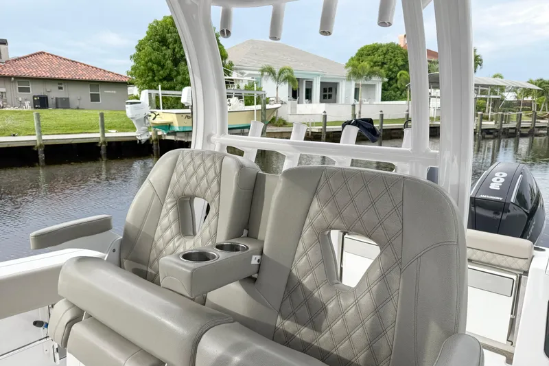 Slide: The Image of 2023 Sportsman Open 322 Center Console boat with luxurious seating and waterfront view. - 6