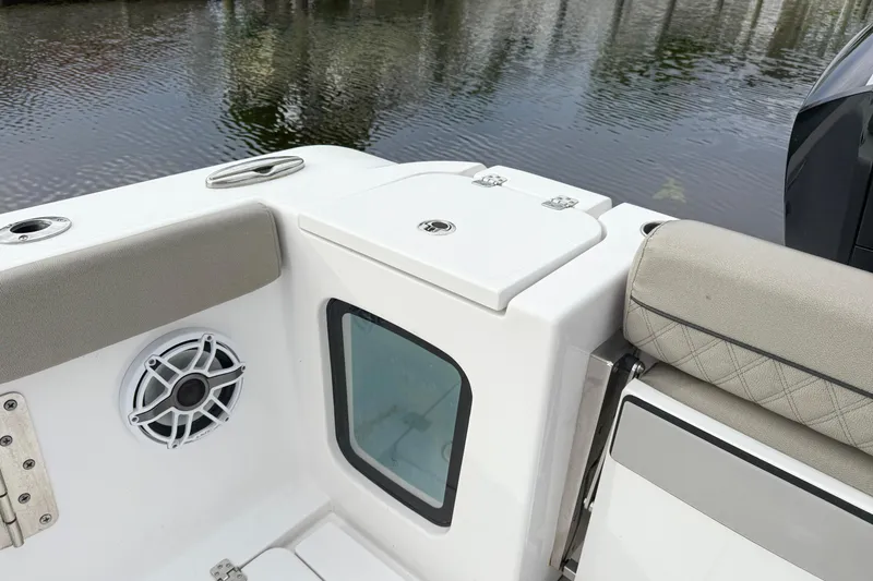 Slide: The Image of 2023 Sportsman Open 322 Center Console boat interior with speaker and seating. - 9