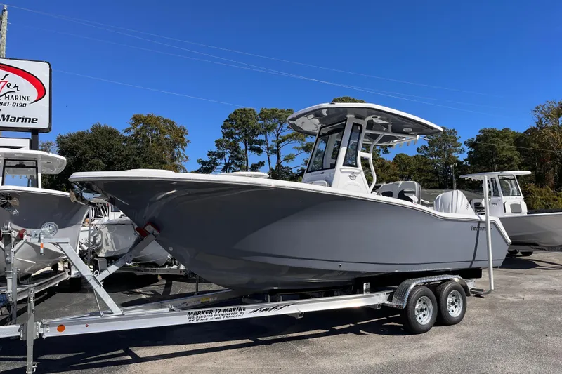 Slide: The Image of 2026 Tidewater 232 CC Adventure boat on trailer, displayed outdoors at a marine dealership. - 1