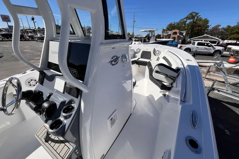 Slide: The Image of 2026 Tidewater 232 CC Adventure boat interior with modern console and seating. - 13