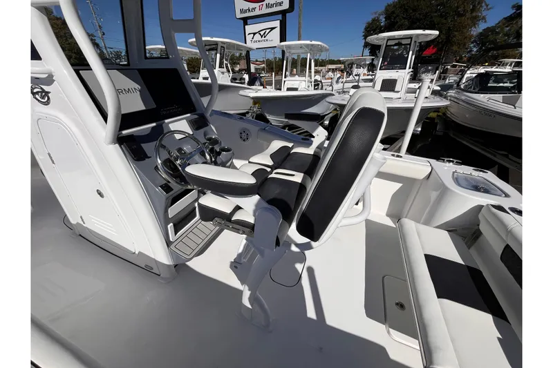 Slide: The Image of 2026 Tidewater 232 CC Adventure boat interior with helm and seating. - 6