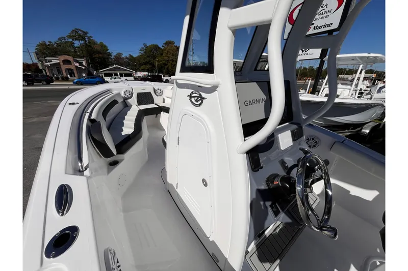 Slide: The Image of 2026 Tidewater 232 CC Adventure boat interior with steering console and seating. - 9