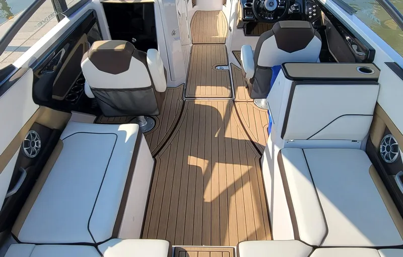 Slide: The Image of 2021 Yamaha Boats 252SD with spacious seating and sleek design at a dock. - 22