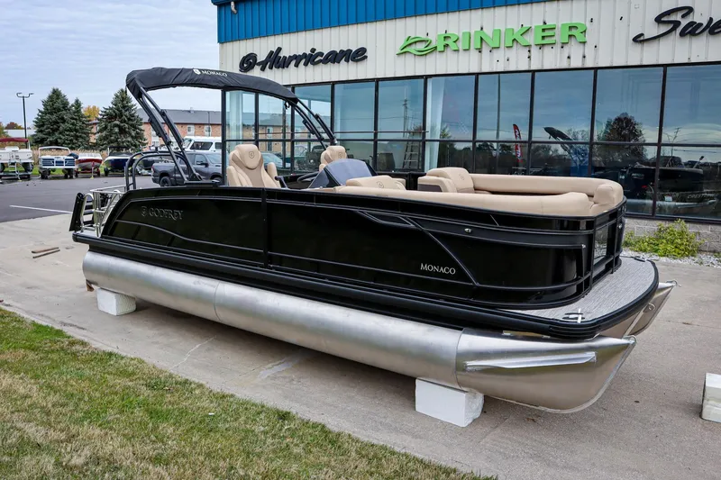 The Image of 2026 Godfrey Monaco 235 SFL pontoon boat displayed outside dealership. - 0