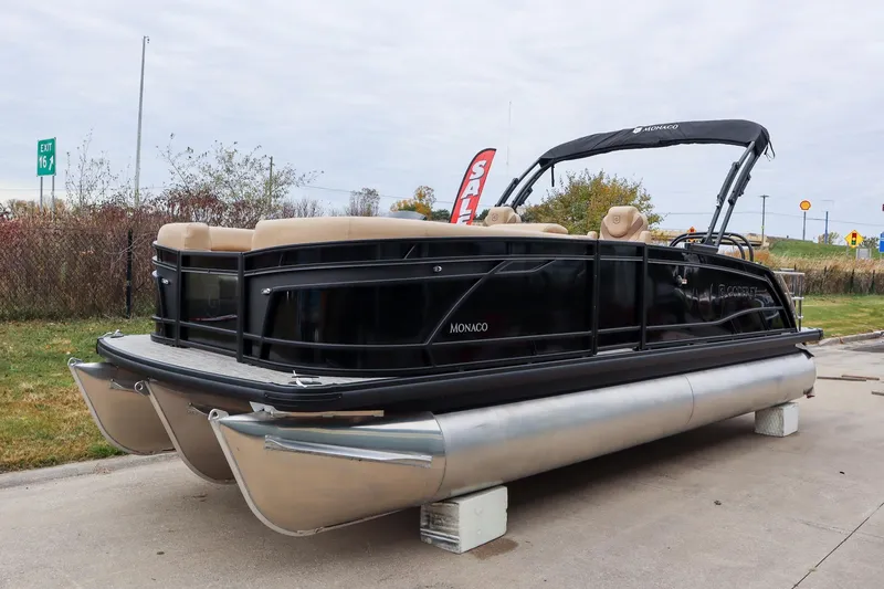 Slide: The Image of 2026 Godfrey Monaco 235 SFL pontoon boat displayed outdoors, featuring sleek black design. - 4