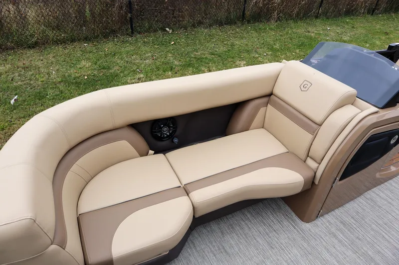 Slide: The Image of Luxurious seating on 2026 Godfrey Monaco 235 SFL pontoon boat, featuring beige and brown upholstery. - 7