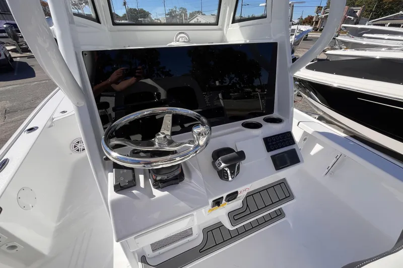 Slide: The Image of 2026 Tidewater 2410 Bay Max boat console with steering wheel and controls. - 12