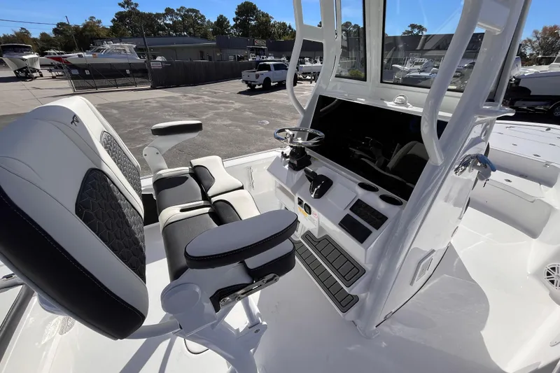 Slide: The Image of 2026 Tidewater 2410 Bay Max boat interior with steering console and seating. - 6