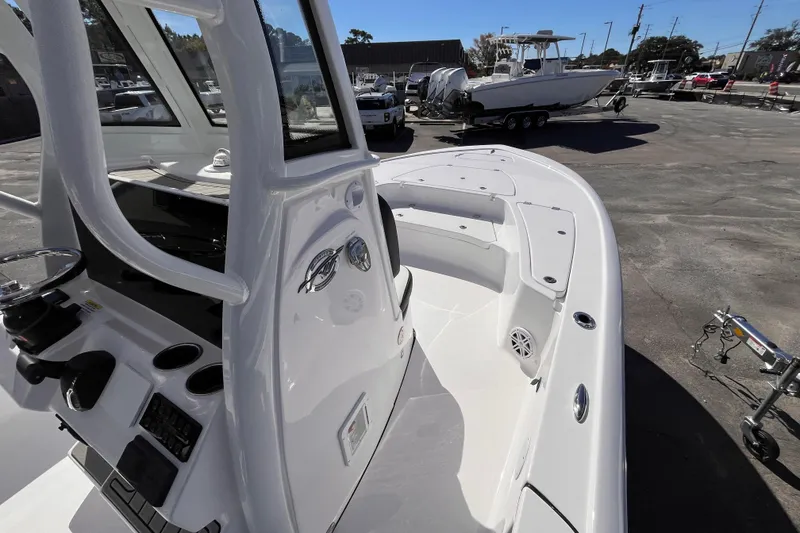 Slide: The Image of 2026 Tidewater 2410 Bay Max boat, sleek design, spacious deck, parked outdoors. - 7