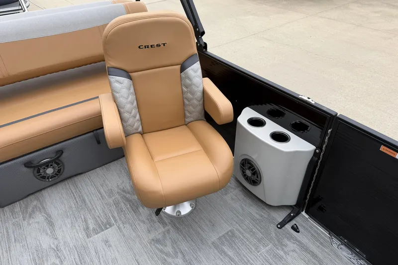 Slide: The Image of Luxurious seating on 2025 Crest Classic 220 boat with cup holders and speaker. - 10