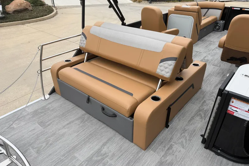 Slide: The Image of 2025 Crest Classic 220 boat interior with tan seating and cup holders. - 13