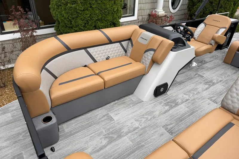 Slide: The Image of 2025 Crest Classic 220 boat interior with tan and gray seating, modern design. - 4