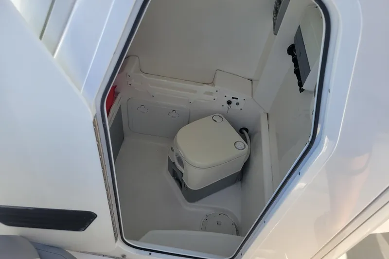 Slide: The Image of 2019 Everglades 255 Center Console boat interior with compact marine toilet. - 11