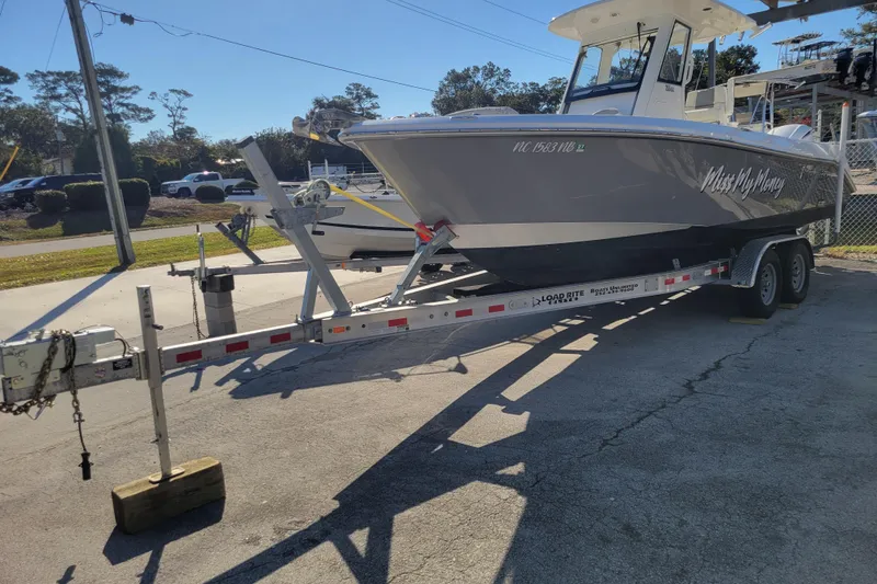 Slide: The Image of 2019 Everglades 255 Center Console boat on trailer in outdoor setting. - 2