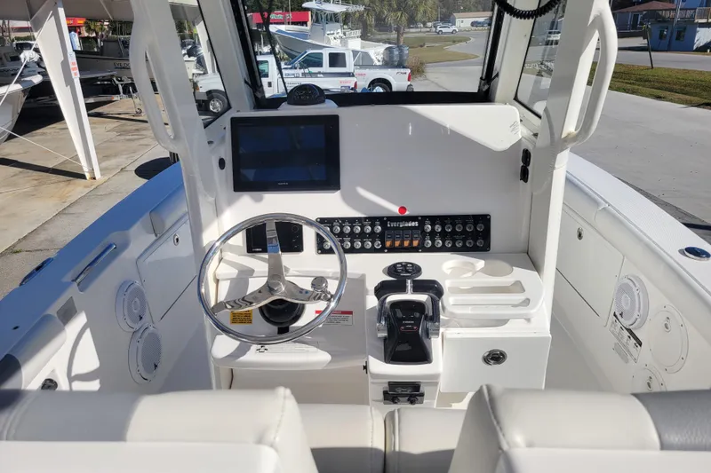 Slide: The Image of 2019 Everglades 255 Center Console boat dashboard with steering wheel and controls. - 7