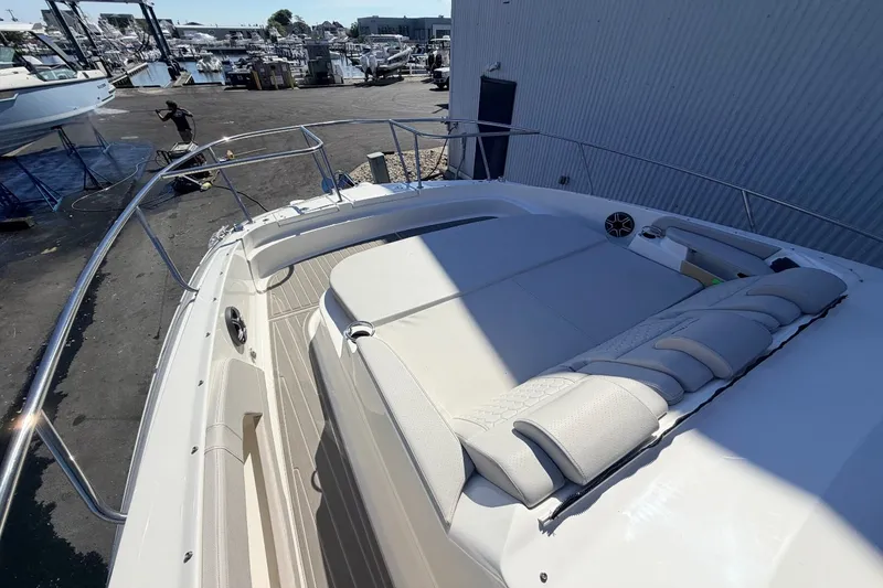 Slide: The Image of The image shows the deck of a 2026 Sea Ray Sundancer 320 Outboard at a marina. - 39
