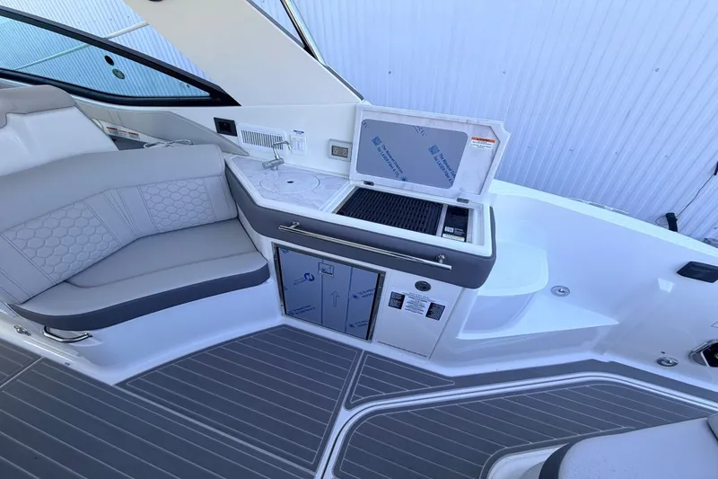 Slide: The Image of Interior of a Sea Ray Sundancer 320 Outboard with gray seating and a small kitchenette. - 18