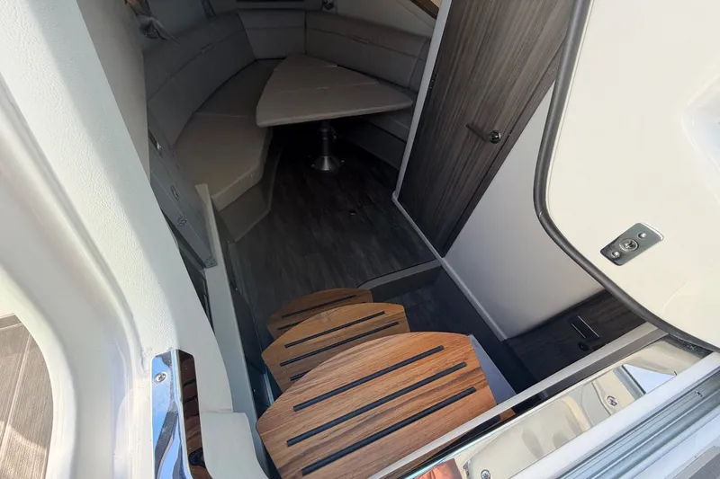 Slide: The Image of Interior of the Sea Ray Sundancer 320 Outboard with wooden flooring and seating area. - 32