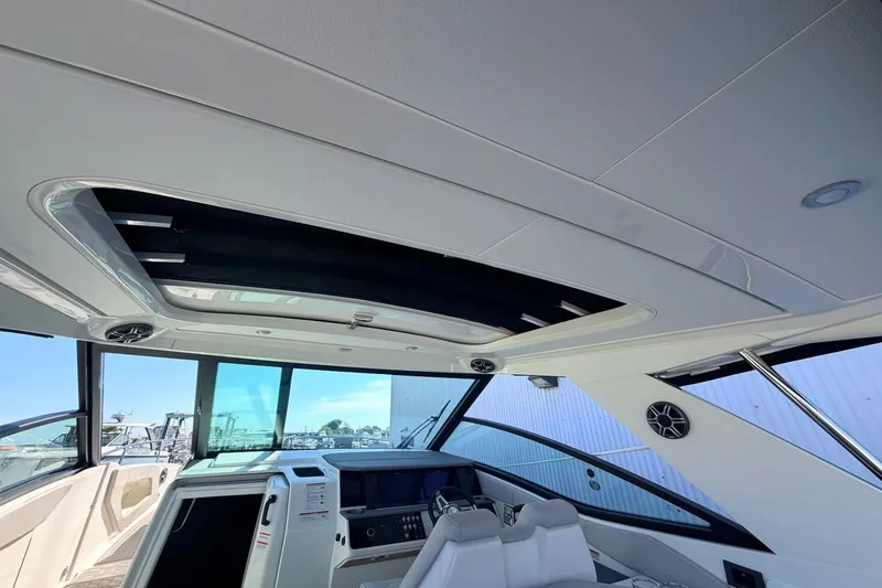 Slide: The Image of Interior view of the Sea Ray Sundancer 320 Outboard with modern cockpit and large windows. - 21