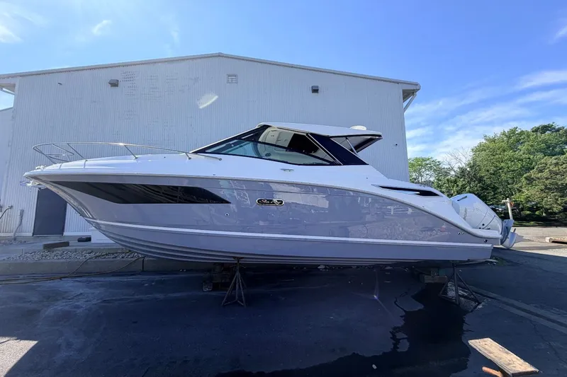 Slide: The Image of 2026 Sea Ray Sundancer 320 Outboard on a dry dock in front of a building. - 8