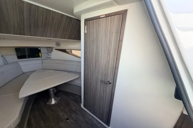 Slide: The Image of Interior of a Sea Ray Sundancer 320 Outboard with sleek seating area and wooden door. - 35