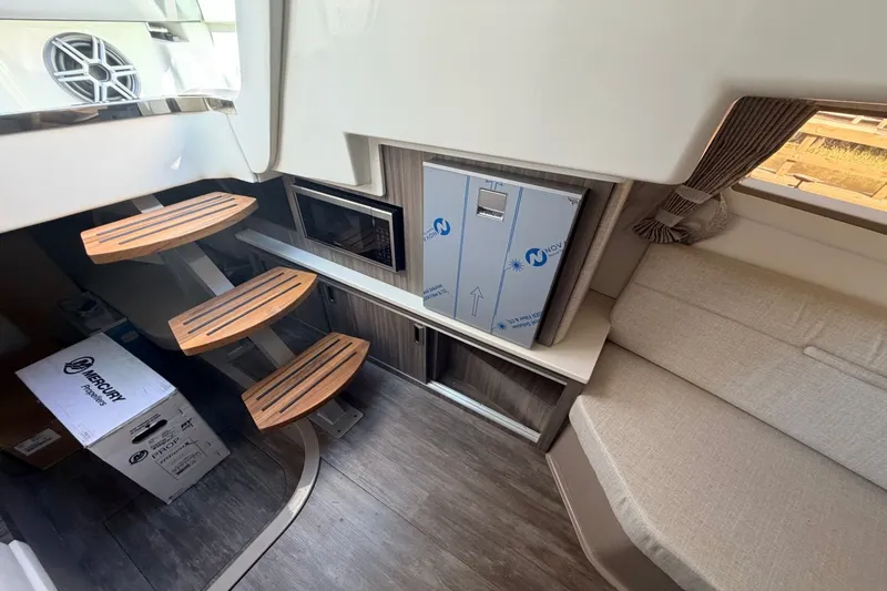 Slide: The Image of Interior of the Sea Ray Sundancer 320 Outboard with modern wood accents and comfortable seating. - 34