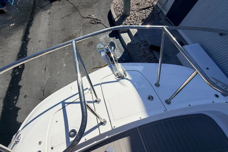 Slide: The Image of The image shows the foredeck of a Sea Ray Sundancer 320 Outboard with stainless steel railing. - 40