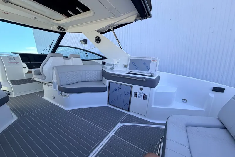 Slide: The Image of Interior of a Sea Ray Sundancer 320 Outboard with gray seating and modern amenities. - 17