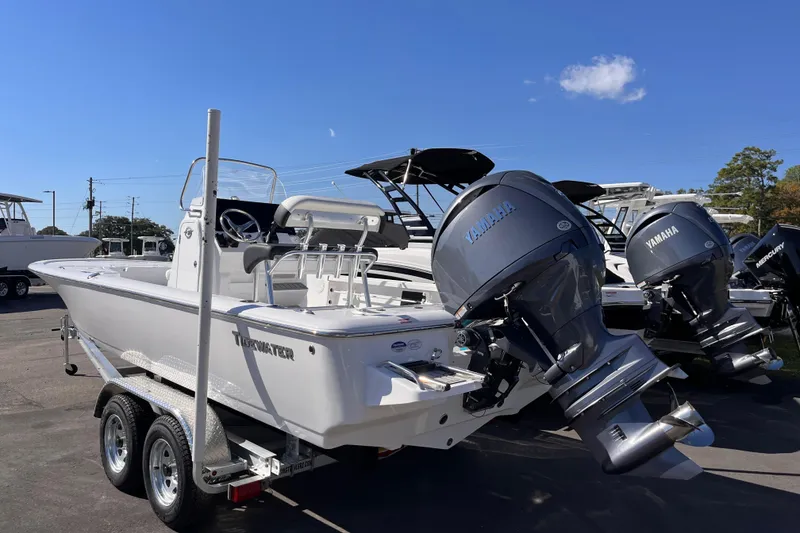Slide: The Image of 2026 Tidewater 2110 Bay Max boat with Yamaha outboard motor on a trailer. - 2