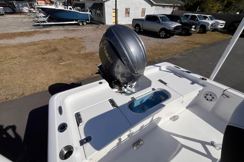 Slide: The Image of 2026 Tidewater 2110 Bay Max boat with Yamaha outboard motor, parked outdoors. - 3